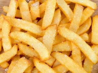 A pile of french fries with salt on top