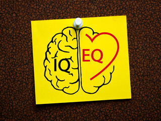 Sticky Note Comparing IQ Brain Logic and EQ Heart Emotion Concept on Cork Board