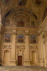 Close-up of beautifully painted frescoes on the walls of an ancient building, showcasing intricate details of historical art. The vibrant colors and craftsmanship highlight the cultural heritage.