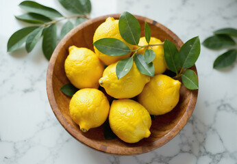 Ripe lemons in a bowl. Fresh organic lemon citrus fruits in wooden plate, healthy vegetarian food cooking ingredients, sour juicy yellow exotic fruits