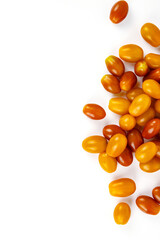 Top view of  fresh yellow and orange cherry tomatoes scattered on white background.   Isolated on clean white backdrop. Food, health, and organic nutrition concepts. Copy space
