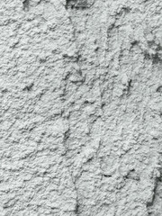 Close-up of a rough textured gray concrete wall.