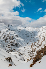 High-angle view of a snow-covered mountain valley in Sierra de Gredos, Spain, with dramatic rocky...