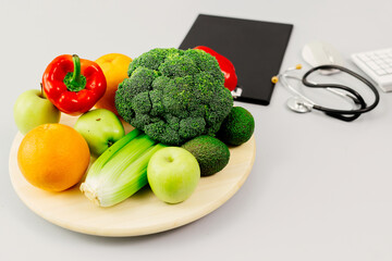 Close-up of organic healthy food with a medical stethoscope on a nutritionist's desk. The concept of healthy eating.