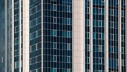 many windows and walls facade of a modern skyscraper without people