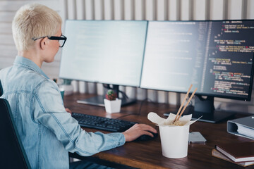 Modern woman working on programming tasks in a stylish home office