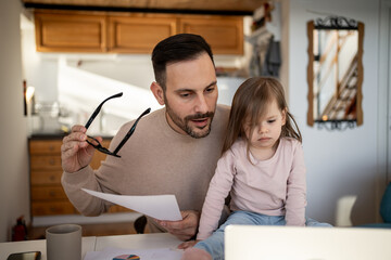 Father managing work and childcare, working from home