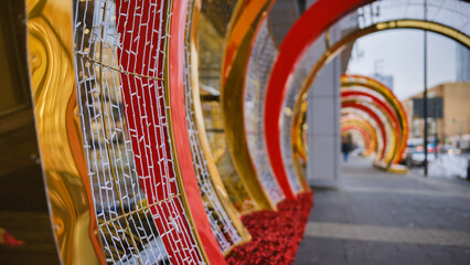 Christmas decorations creating a tunnel of lights in a city street