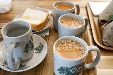 Popular drink in Malaysia called Teh Tarik. It is a sweet drink made from tea with milk. Fractal on the cup is generic print.