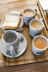 Popular drink in Malaysia called Teh Tarik. It is a sweet drink made from tea with milk. Fractal on the cup is generic print.