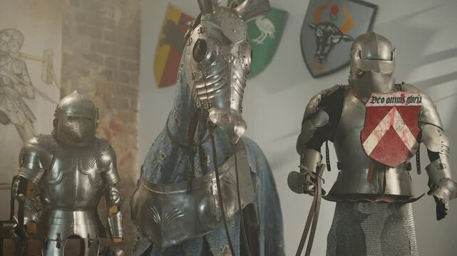 Antique knight and horse armor displayed. Memory of ancient heroes. shields on the wall.