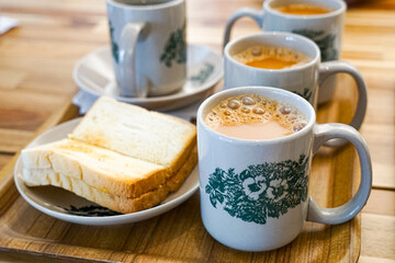 Popular drink in Malaysia called Teh Tarik. It is a sweet drink made from tea with milk. Fractal on the cup is generic print.