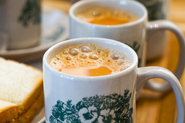 Popular drink in Malaysia called Teh Tarik. It is a sweet drink made from tea with milk. Fractal on the cup is generic print.