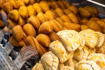 A showcase full of diverse pastries and fried food items