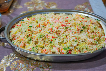 Nasi Hujan Panas, a traditional Malaysian dish featuring vibrant, colorful rice infused with...
