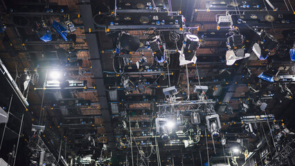 Lighting equipment hanging from ceiling in television studio