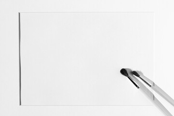 Black and White Closeup of Painting Brushes on Blank Kraft Paper with Passepartout Frame. Art...