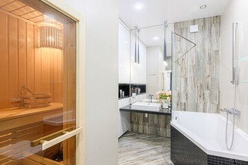 modern bathroom with a sauna, featuring sleek design elements like wood-look tiles, a minimalist vanity, and contemporary lighting