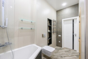 modern bathroom with a sauna, featuring sleek design elements like wood-look tiles, a minimalist vanity, and contemporary lighting