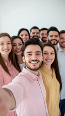 Group of cheerful friends posing together for a selfie in a bright room.