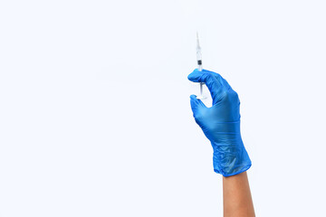 doctor's hand in blue gloves holds a medical syringe for injection, syringe in hand on white background copy space