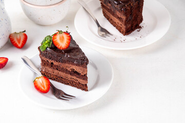 Dark chocolate cake slices, with chocolate cream and strawberry