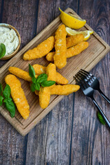  Crispy home made  deep fried   chicken strips . Breaded  with cornflakes chicken  breast fillets  with chilly peppers and fresh   basil on wooden rustic background