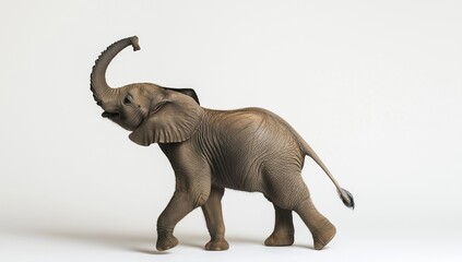 Obraz premium Gray elephant figurine with trunk raised.