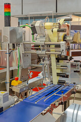 Automated Labeling Machine at Conveyor Belt in Food Production Factory