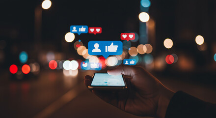 Hand Holding Smartphone Showing Social Media Notifications at Night with City Lights Background