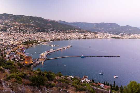 A stunning elevated view showing a large coastal city with a scenic harbor