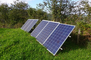 Solar panels converting sunlight into electricity in green field