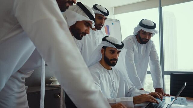 Cinematic video of a group of businessmen from UAE during an corporate meeting in an office. Locals men in kandura making business together.