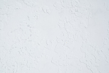 White plaster wall with rough textured surface closeup
