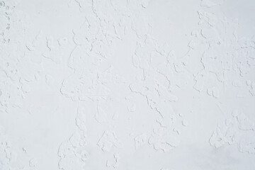 White plaster wall with rough textured surface closeup
