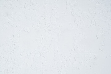 White plaster wall with rough textured surface closeup