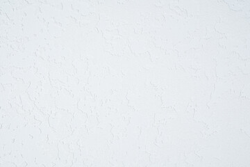White plaster wall with rough textured surface closeup