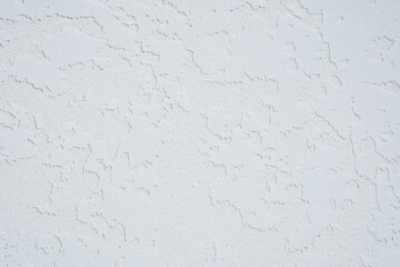 White plaster wall with rough textured surface closeup..