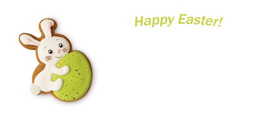 Gingerbread in the shape of a rabbit with an Easter egg decorated with colored icing on a white background with Easter inscription. Banner