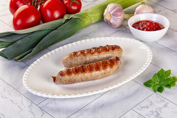 Grilled pork sausages served tomato sauce