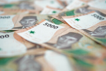 stack of five thousand rupiah banknotes, Indonesian money. suitable for background, finance, banking, cash, savings.