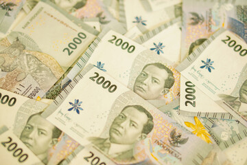 A stack of two thousand rupiah banknotes, Indonesian money. suitable for background, finance, banking, cash, savings.