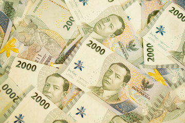 A stack of two thousand rupiah banknotes, Indonesian money. suitable for background, finance, banking, cash, savings.