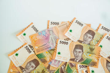 a stack of five thousand rupiah banknotes with negative space, which is Indonesia. suitable for background, finance, banking, cash, savings.