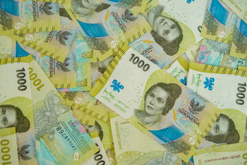 A stack of thousand rupiah banknotes, Indonesian money. suitable for background, finance, banking, cash, savings.