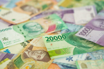 Various stacks of Indonesian banknotes, from one thousand rupiah to twenty thousand rupiah. Suitable for background, finance, banking, cash, savings.