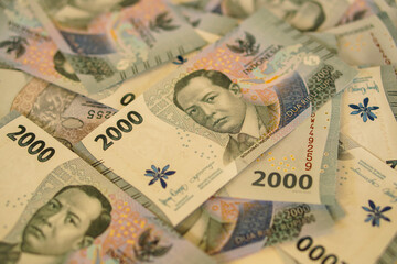 A stack of two thousand rupiah banknotes, Indonesian money. suitable for background, finance, banking, cash, savings.