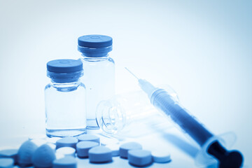 Medical Vials, Syringe, and Pills Representing Healthcare and Medication