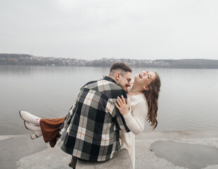 Fototapeta premium Smile with braces. Beautiful girl with braces on a date. Young people dancing, kissing and hugging, enjoying the meeting
