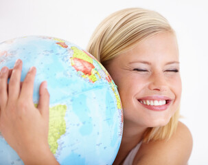 Woman, travel and globe hug with study and happy from earth day, holiday or international vacation. Smile, world and map for learning and geography with a female person and embrace of the planet